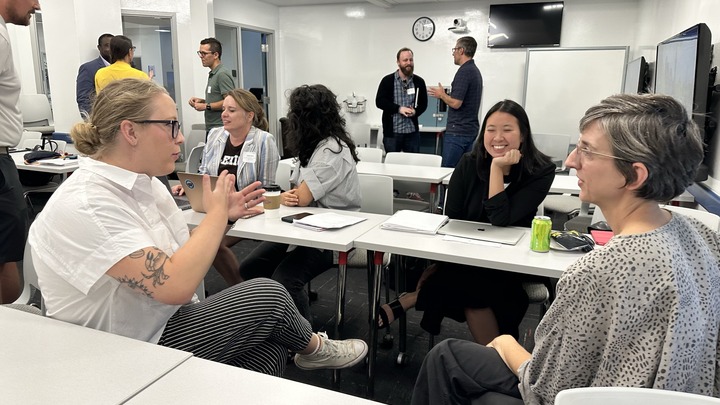 Faculty talking in groups