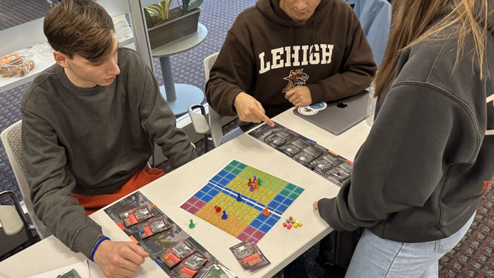 Students showcasing the boardgame they made