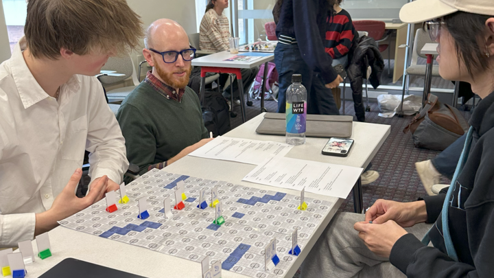 Students showcasing the boardgame they made