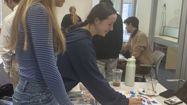 Students showcasing the boardgame they made