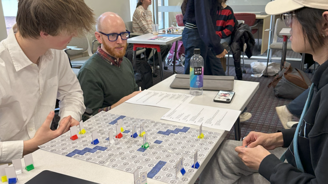 Students showcasing the boardgame they made