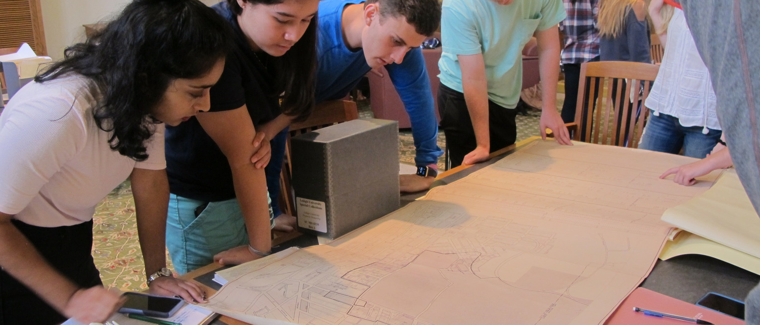 Students look at unrolled map during class visit