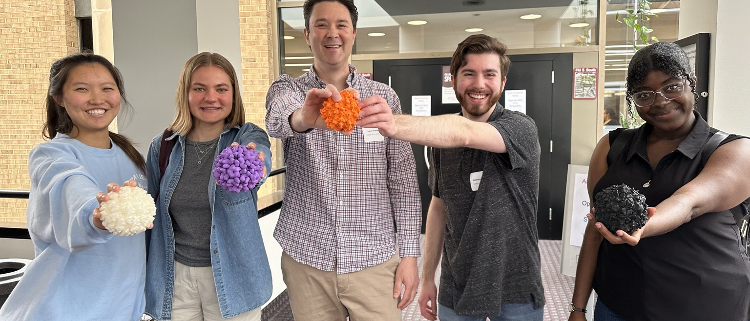 Professor Tartaglia and students with 3D printed virus models