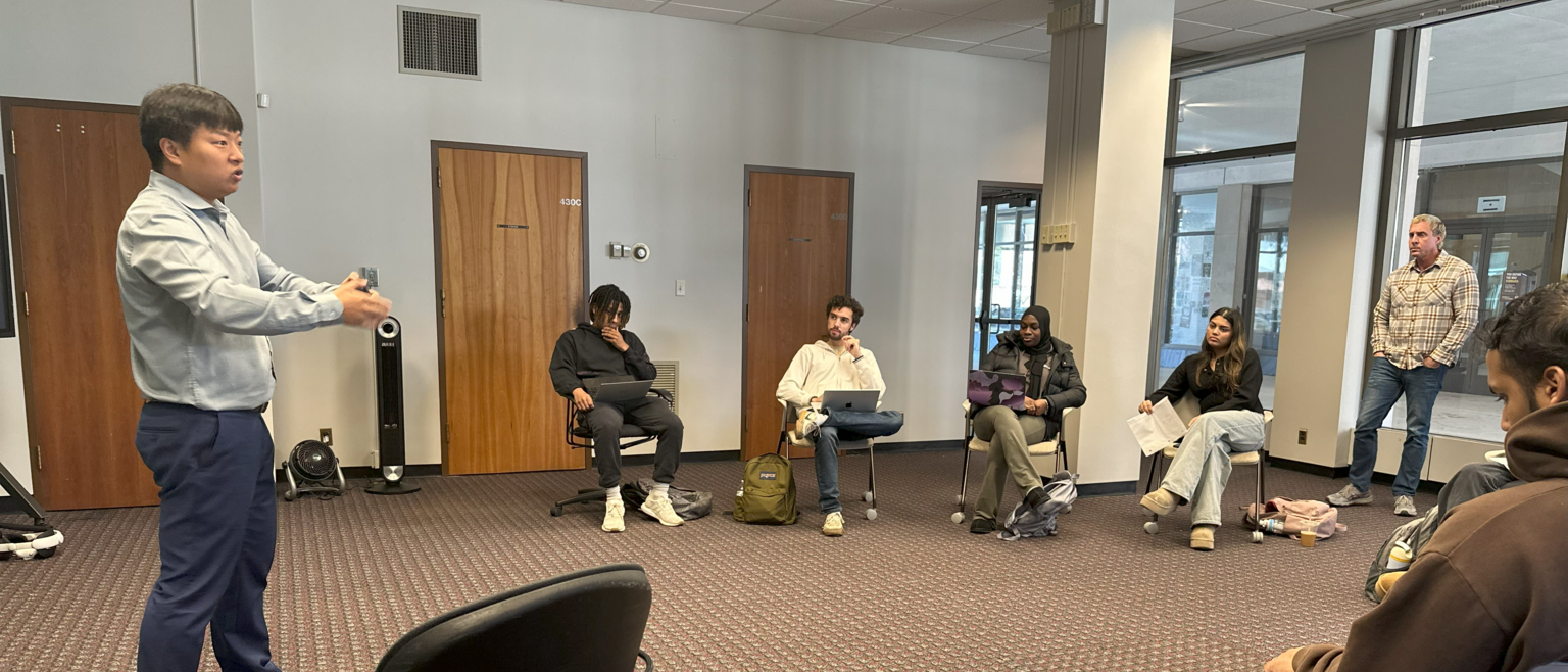 Students discussing their exercise app ideas with professor