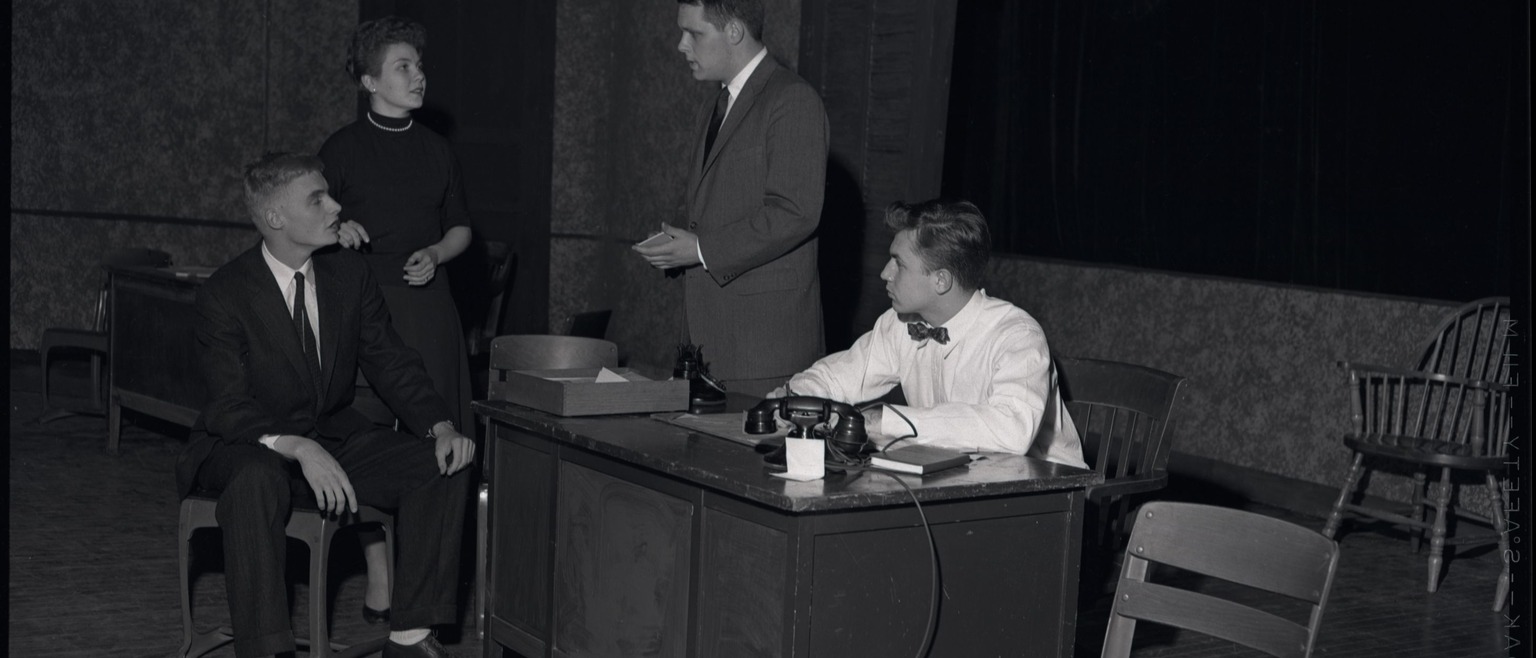 Three men and a woman at an interview
