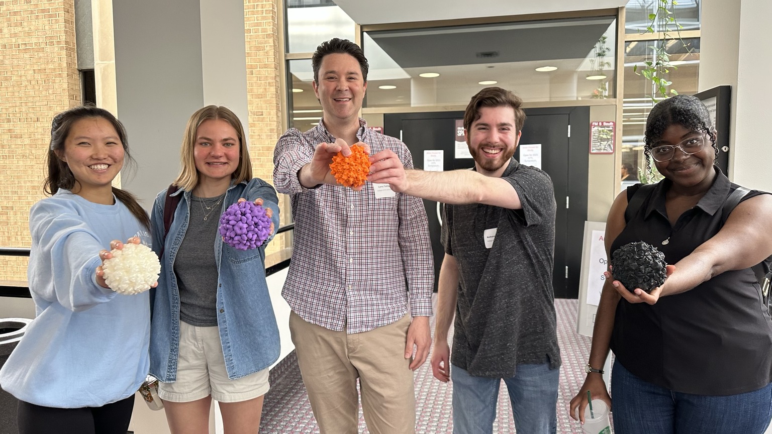 Professor Tartaglia and students with 3D printed virus models